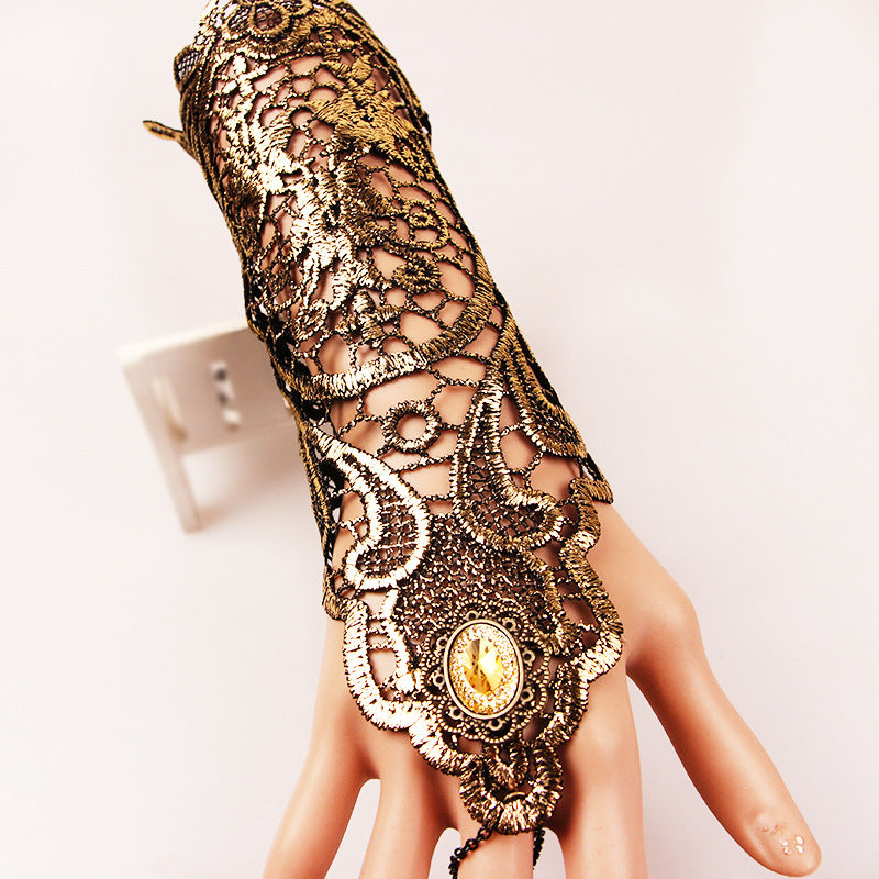 A mannequin's hand with an ornate wrist cuff showcasing Shine On! Vintage Gold Lace Gloves for Refined Retro Style by Maramalive™.