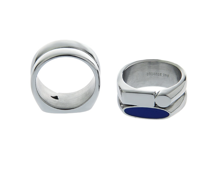 A woman's hand is holding a silver ring and a Maramalive™ Blue Minimalist Ring.