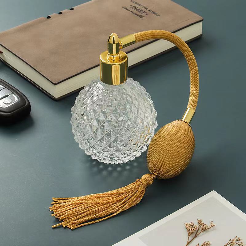 Three Renaissance Scent in a Clever French Perfume Bottle with Airbags bottles with tassels on a table by Maramalive™.
