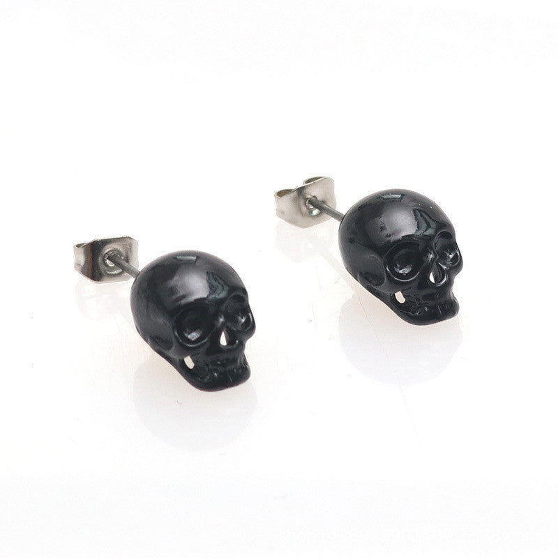 A woman's ear with a Personality Retro Skull Eardrops earring from Maramalive™.