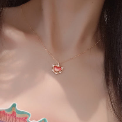 A woman is wearing a Maramalive™ Sterling Silver Peach Amethyst Heart Necklace.