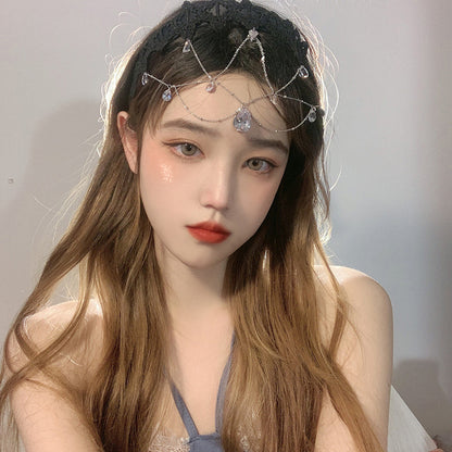 A girl wearing a Water Drop Gem Hair Jewelry Photography Mask Jewelry headband by Maramalive™ with crystals on it.