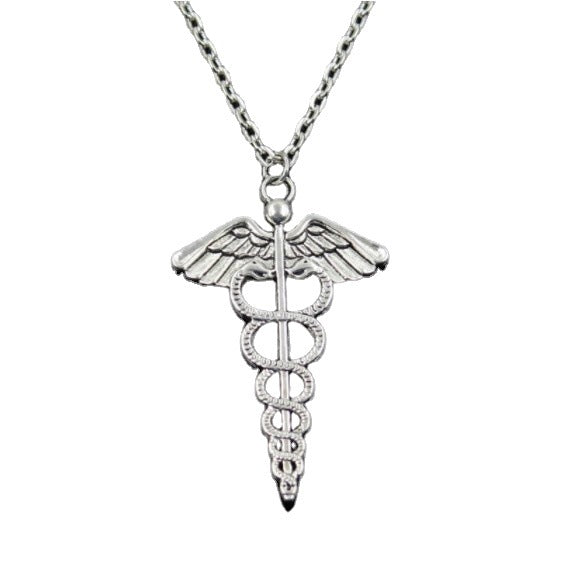 A Maramalive™ Rotating Dragonfly Snake Stick Angel Wings Necklace with a medical symbol in a box.
