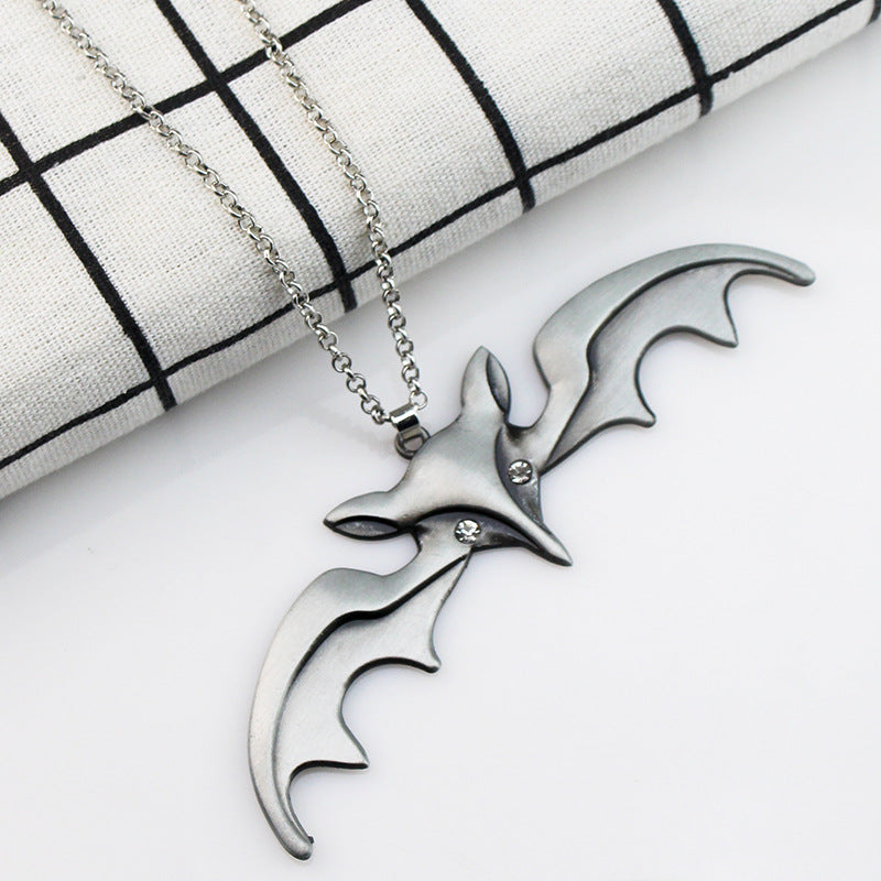 A Maramalive™ Halloween Animal Bat Wing Diamond Necklace is sitting on top of a wooden box.