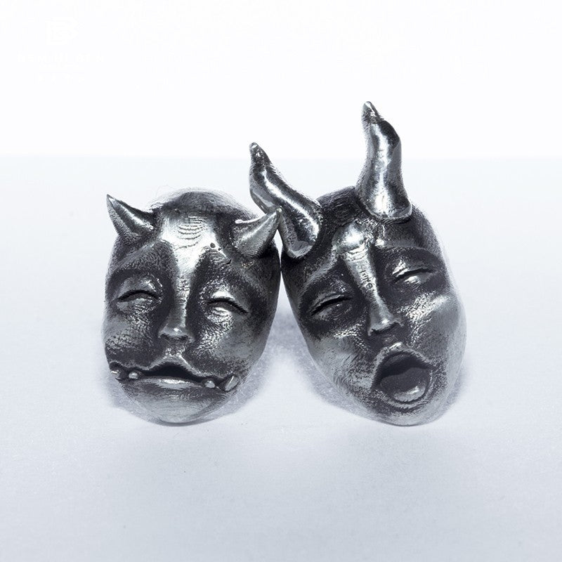 A pair of Gothic Horned Demon Baby Face Stud Earrings Vintage Devil Prajna by Maramalive™ on a white surface.