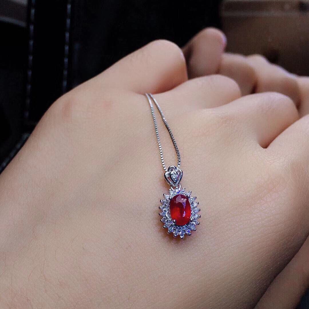 A woman's hand holding a Maramalive™ Burmese Ruby Crystals in Traditional Jewelry Sets.