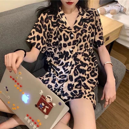 A woman wearing a Retro Gothic Leopard Print Cardigan from Maramalive™ lounging on a retro-inspired couch.