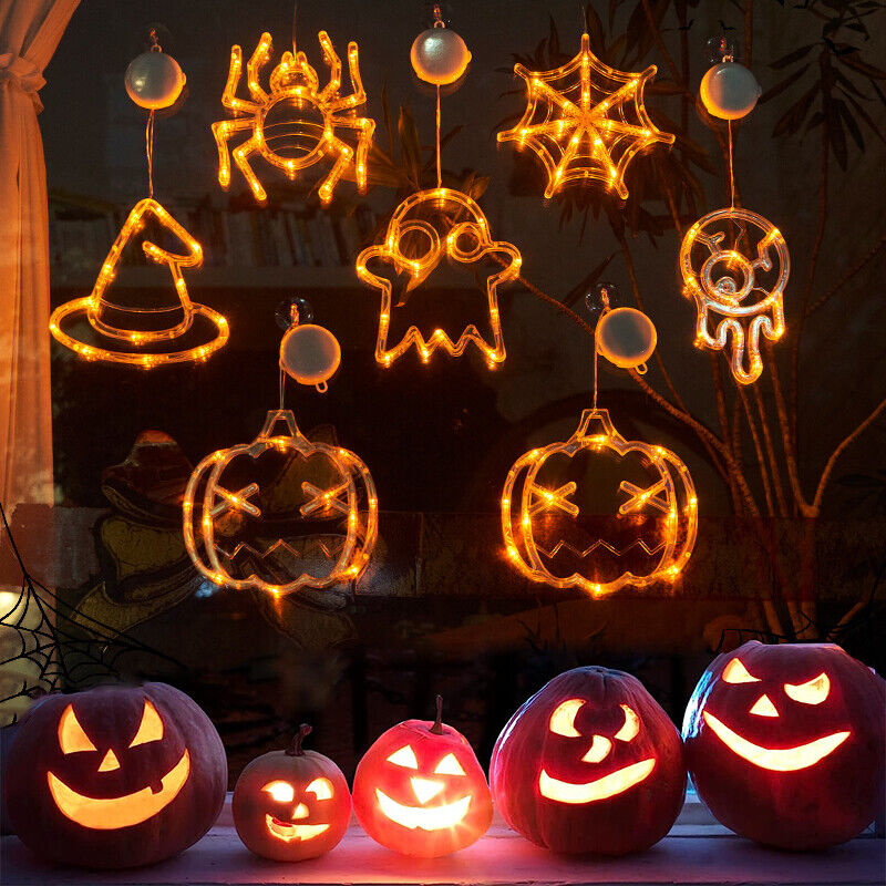 A group of carved pumpkins displayed in front of a window for Maramalive™ Halloween Window Hanging LED Lights Spider Pumpkin Hanging Ghost Horror Atmosphere Lights Holiday Party Decorative Lights Home Decor decorations.