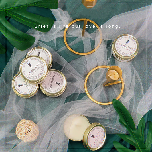 A set of Maramalive™ gold tins with Indoor Long-lasting Aromatic Candles At Home and green leaves.