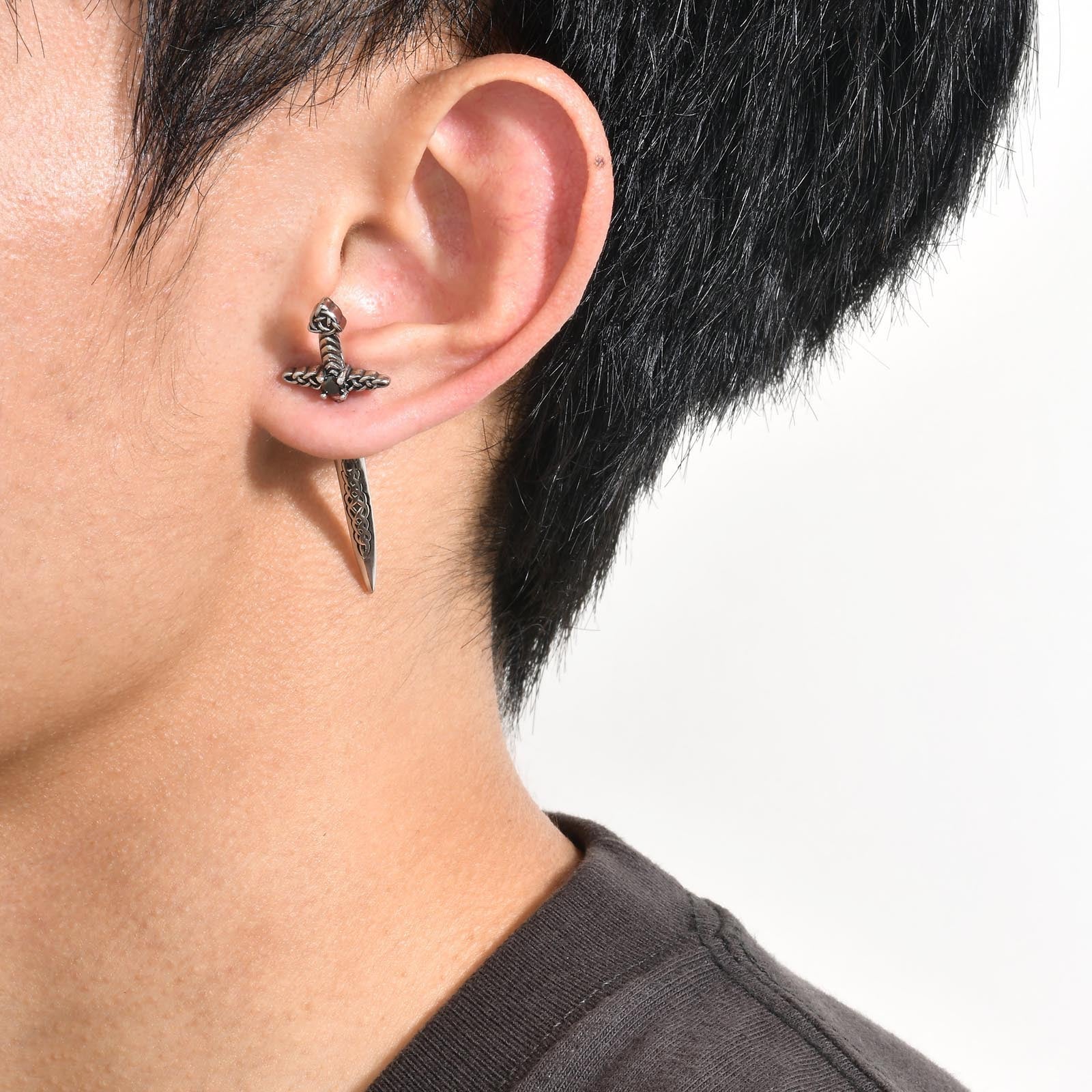 A man wearing a pair of Maramalive™ Stainless Steel Black Retro Hip Hop Sword Ear Studs.