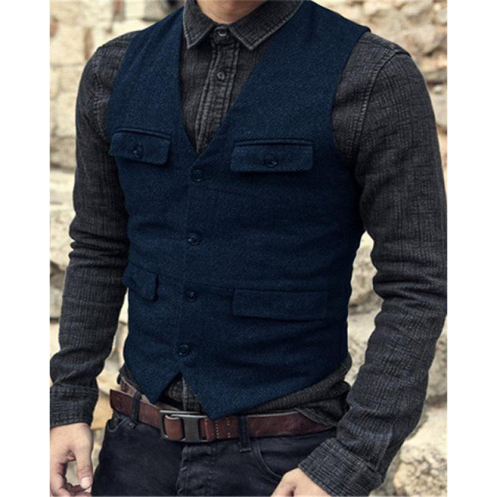 A person wearing a Maramalive™ European And American Men's Vest Casual Solid Color Herringbone Vest over a buttoned-up, cotton blend dark gray shirt with rolled-up sleeves, and a brown belt.