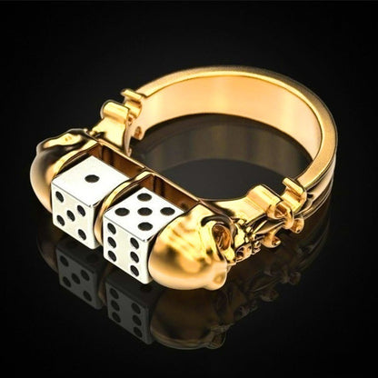 A Maramalive™ gold ring with a striking skull and dice on it.