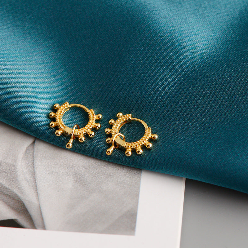 A pair of Minimalist Stainless Steel Bridal Earrings by Maramalive™ on a blue cloth.