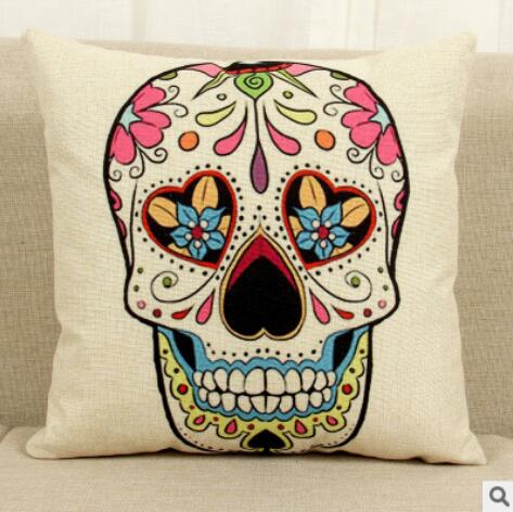 A Maramalive™ cushion with a sugar skull and roses on it.