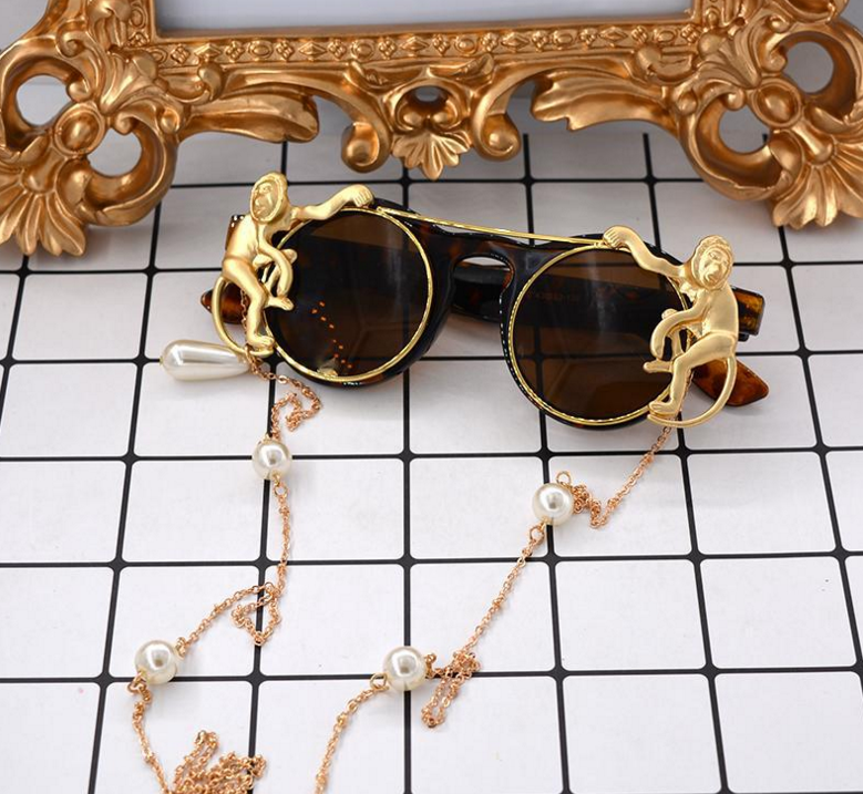 A pair of Maramalive™ Steampunk Vintage Sunglasses with a chain attached to them.