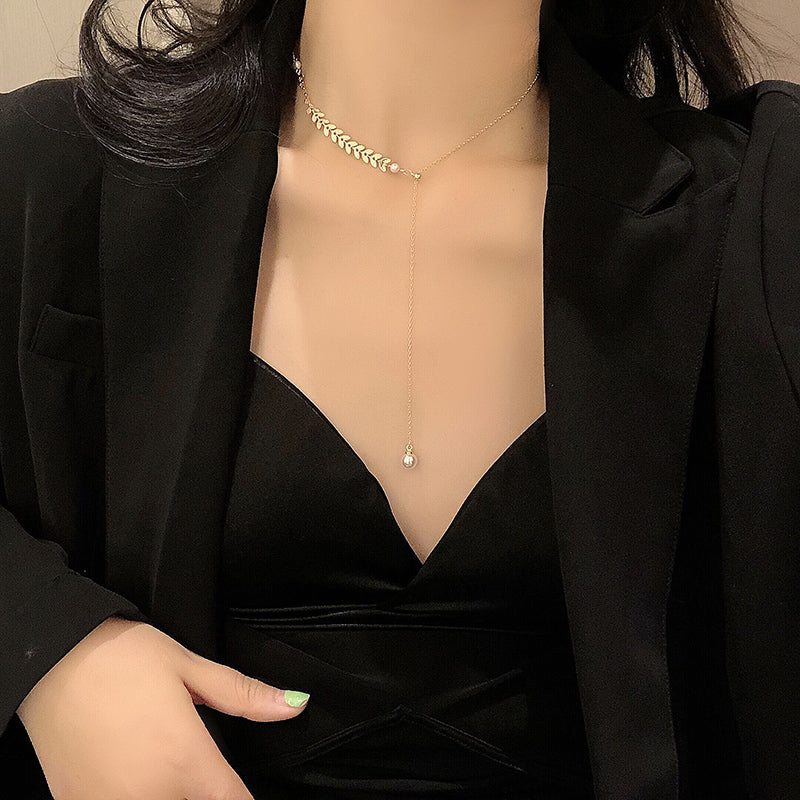 A woman wearing a black jacket and a Maramalive™ Retro Clavicle Chain necklace.