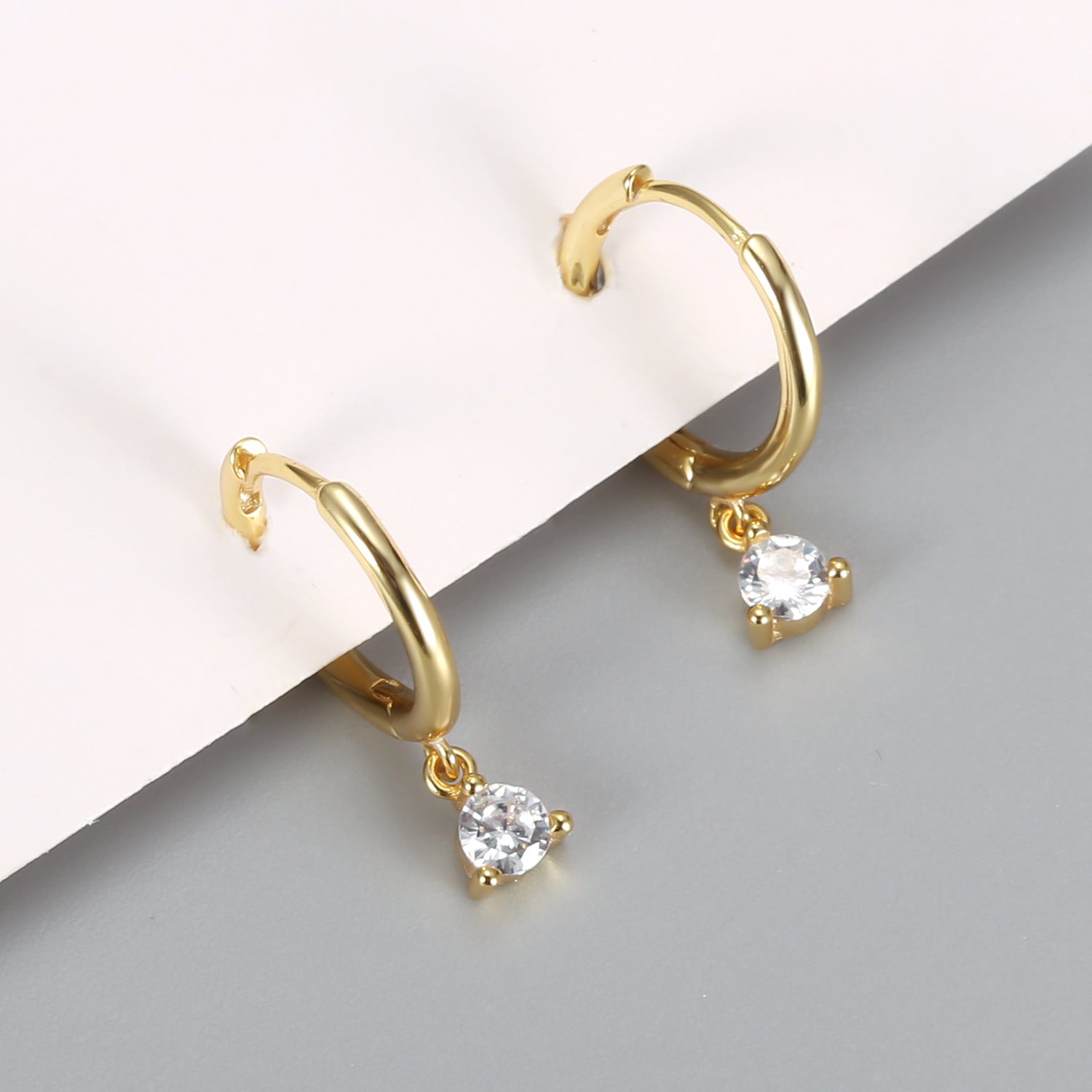 A pair of Maramalive™ Diamond Earrings with a cubic zirconia.
