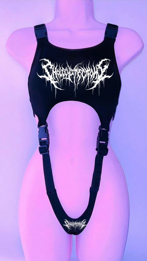 A black harness with intricate white lettering and adjustable straps, crafted from black faux leather material, displayed against a pink and purple background, features the '90s Throwback Y2K Gothic Style Cropped Vest for Goths by Maramalive™.