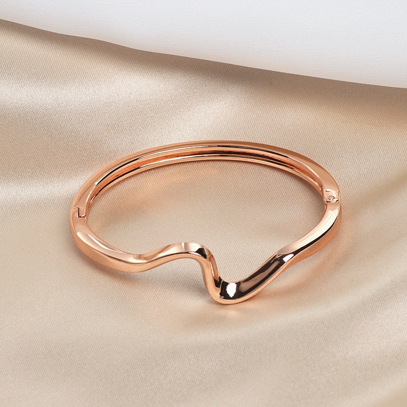 A Maramalive™ Gold-plated Minimalist Lightning Bracelet with a curved shape.
