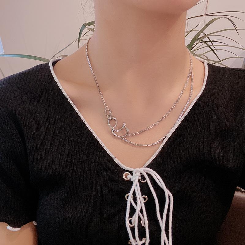 A woman wearing a black top and a Maramalive™ Hip-hop Clavicle Chain Design.