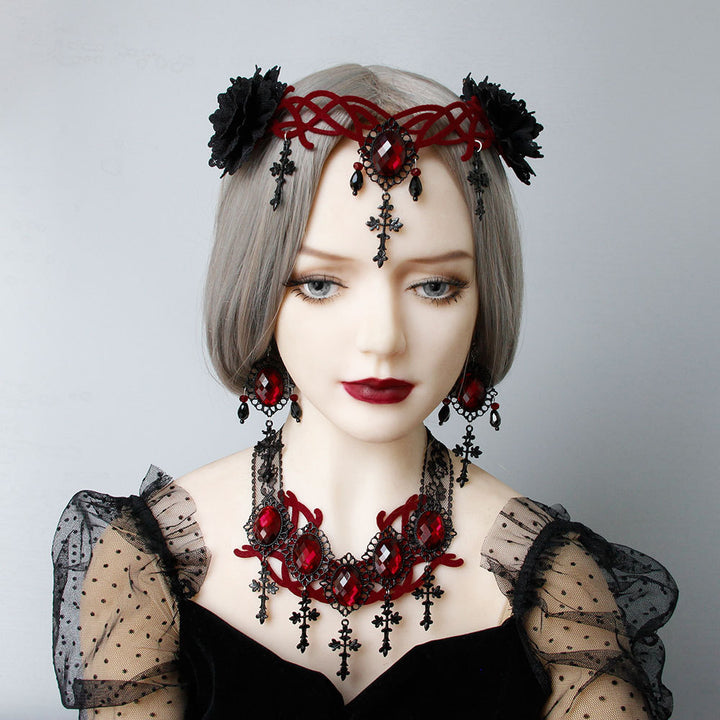 A mannequin displaying a Gothic Style Vampire Death Role Playing Cross Headdress by Maramalive™ in black attire with red jewelry.