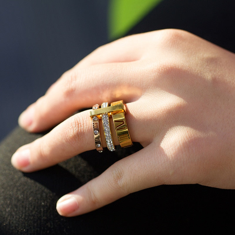 A woman's hand with a Roman Wild Titanium Steel Letter Ring by Maramalive™ on it.