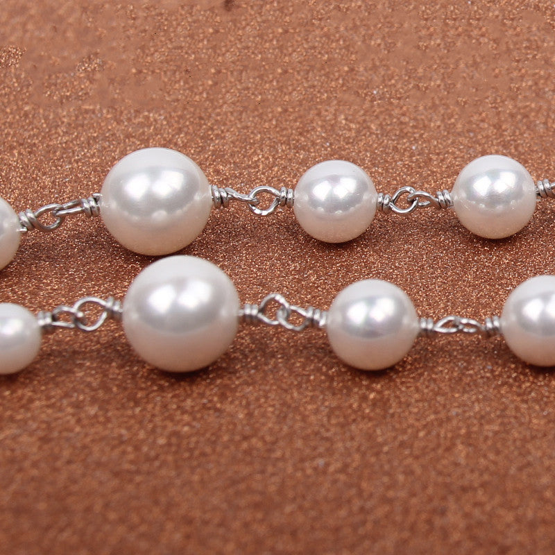 A Maramalive™ Shell Pearl Necklace on a gray background.