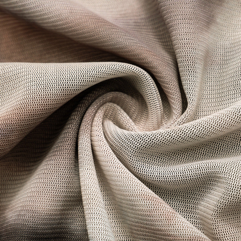 A close-up of a beige and brown textured Maramalive™ Printed Off-neck Long Sleeve Backless Pleated Top with a swirling pattern in its folds.