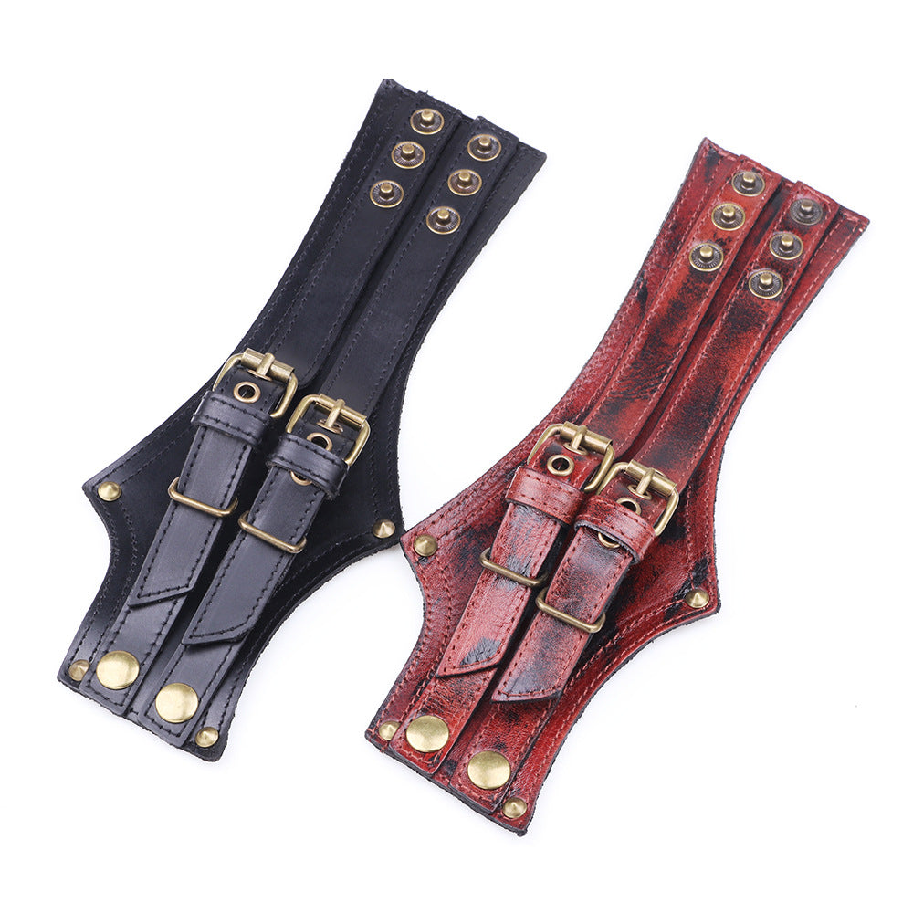 A Punk Wristband by Maramalive™, composed of red leather and featuring brass buckles.
