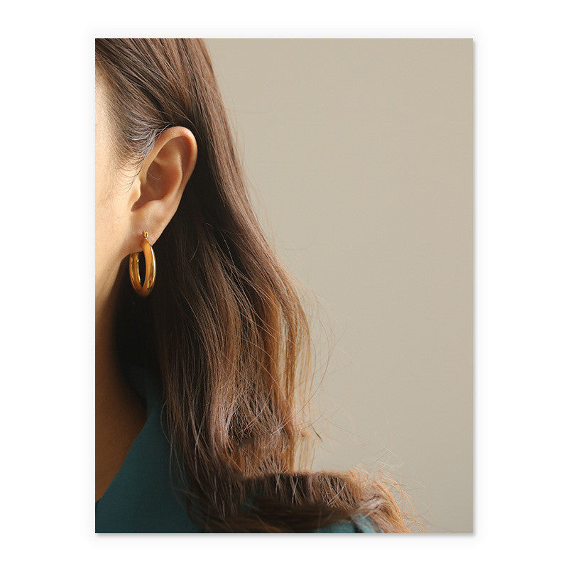 A pair of Circle Earrings by Maramalive™ on a white background.