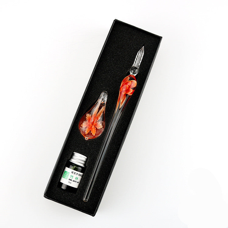 A person holding an Elegant Crystal Flower Glass Dip Pen Set with a flower in it.