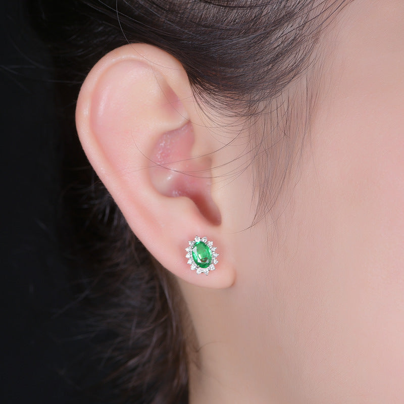 A pair of Versatile Crystal Earrings by Maramalive™, consisting of ruby and diamond studs.