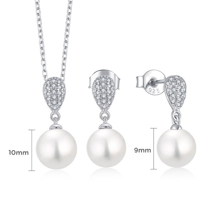 A Maramalive™ I'm Gonna Cry Until I Get One Sterling Silver Zircon Pearl Necklace and earring set on a white table.