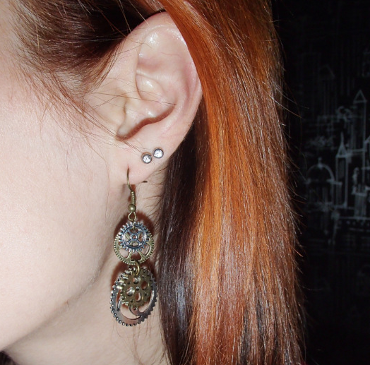 A pair of Maramalive™ Bronze Steampunk Earrings with gears on them.