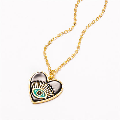 A black and green Demon Eye Necklace with a gold chain from Maramalive™.