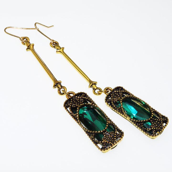A pair of Maramalive™ Vintage bronze earrings with emerald green glass.