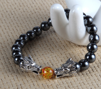 An Obsidian Double Dragon Bracelet with two dragon heads on it by Maramalive™.