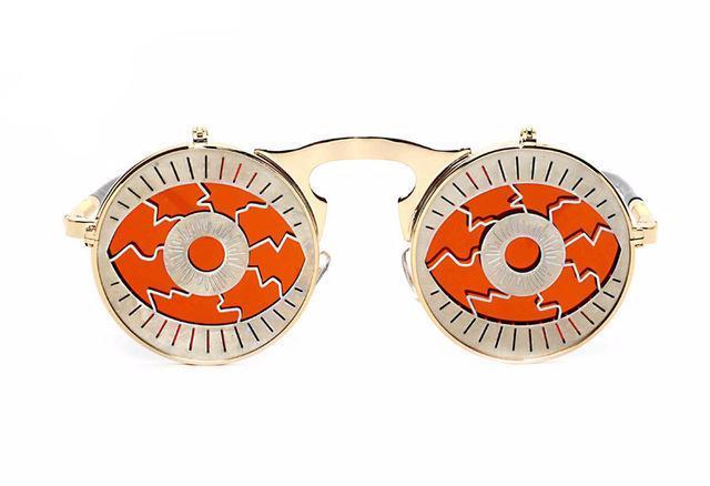 A pair of Maramalive™ Steampunk Flip Sunglasses with an orange and gold design.