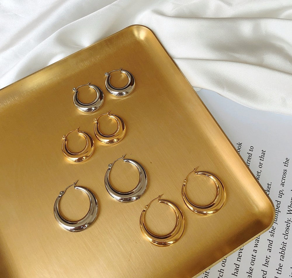 Luxury earrings by Maramalive™ on a gold tray.