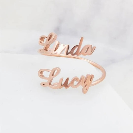 A Maramalive™ Adjustable Personalized Ring: Customizable with One or Two Names, with the words linda and lucy on it.