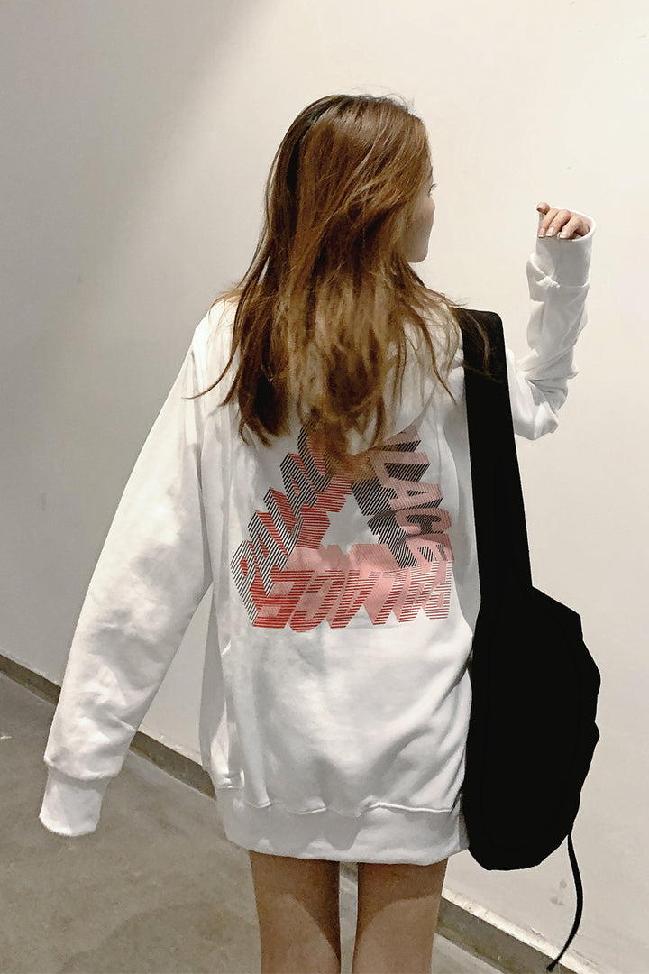 Person with long hair in a white **Maramalive™ Phantom hoodie** featuring a red and black design on the back, carrying a black bag. Embodying youth fashion, they face away from the camera against a plain wall, showcasing an effortless hip hop vibe perfect for autumn and winter.