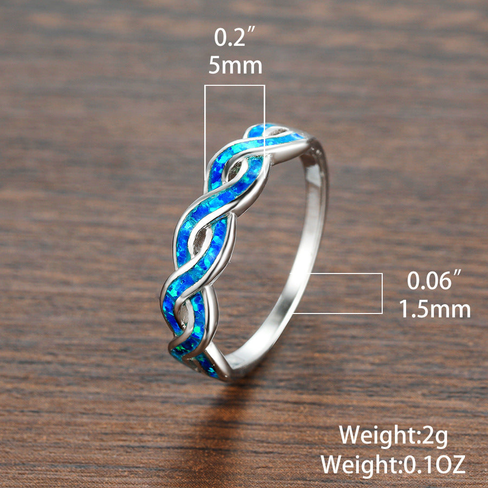 A person holding a blue Maramalive™ Opal Twist Ring.