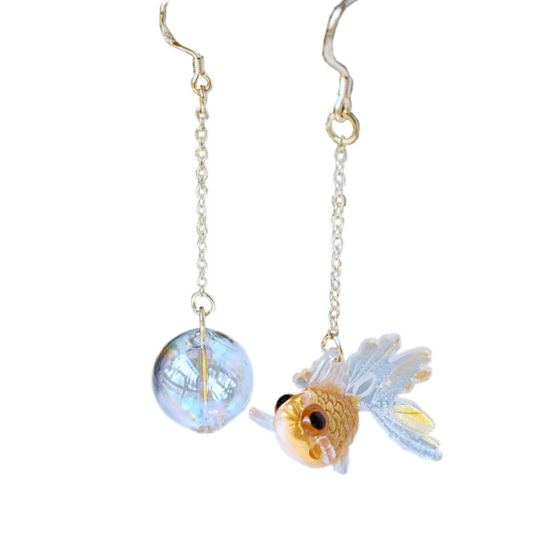 A pair of Goldfish Earrings with a fish and a glass ball by Maramalive™.