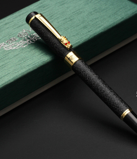 A Maramalive™ Classic Design Brand Hero Dragon Crystal Ink Fountain Pen sitting on top of a green box.