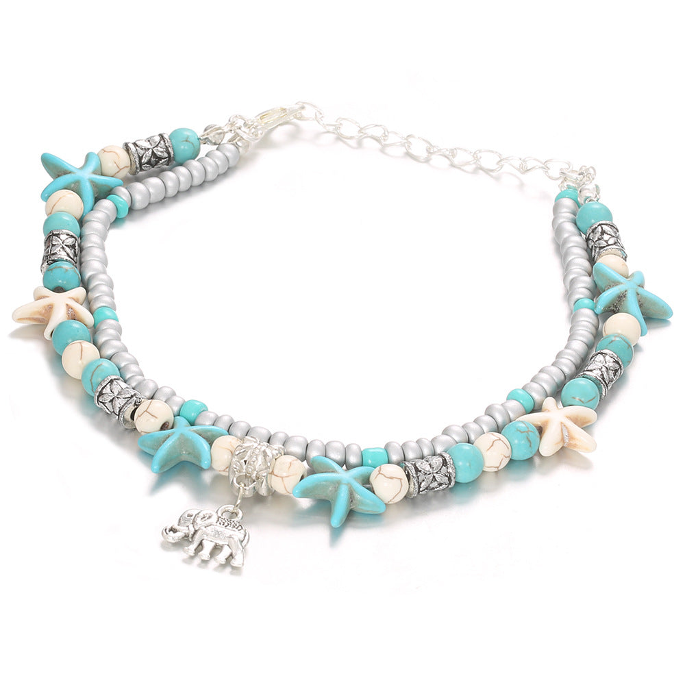 A Double Sea Star Bead Jewelry bracelet with three white shells on a blue cord by Maramalive™.