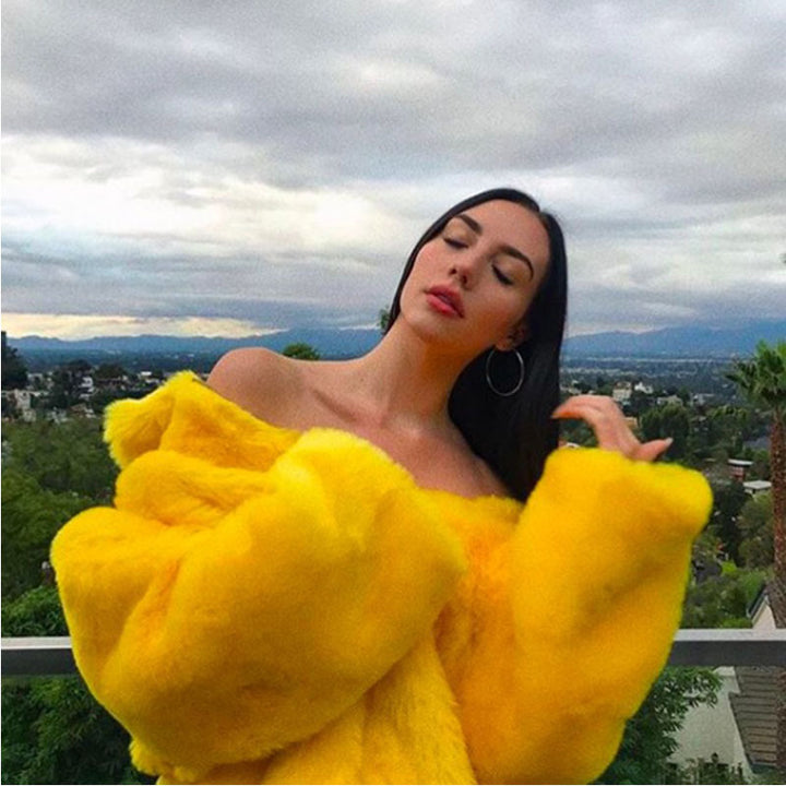 A woman flaunting a medium-length, yellow Maramalive™ Bright Yellow Plunk Faux Fur Coat - Cool Fake Fur Jacket