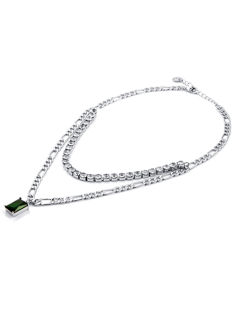 A woman wearing a white top and an Imported Rhinestone Clavicle Chain Necklace - Light Luxury Design with green stones from the brand Maramalive™.