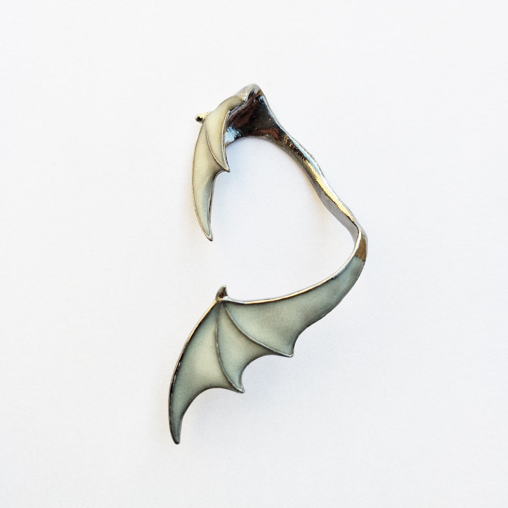 A woman wearing a pair of Glow-in-the-Dark Dragon Wing Earrings from Maramalive™.