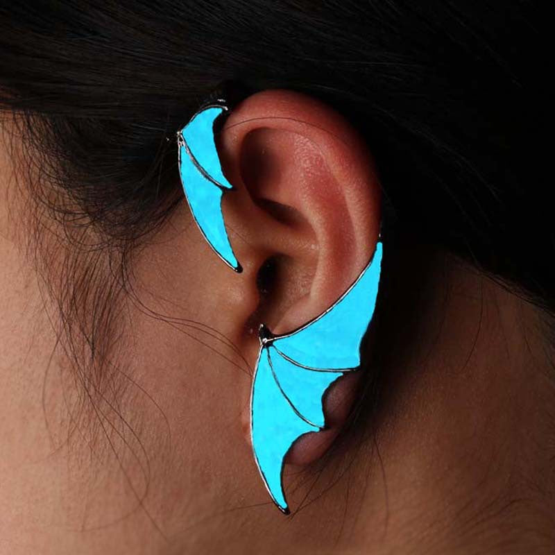 A woman wearing a pair of Glow-in-the-Dark Dragon Wing Earrings from Maramalive™.