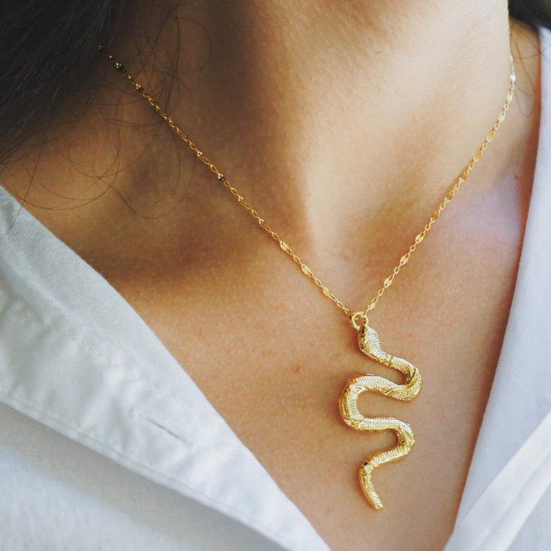 A woman wearing a Snake Dangle Pendant Necklace - Minimalist Style, Trendy Birthday Gift from Maramalive™.